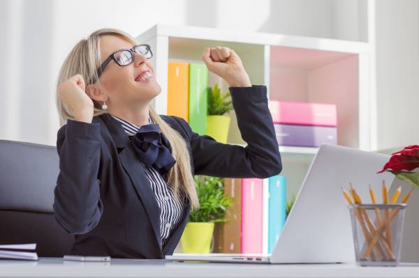 Happy young business woman enjoying success at work