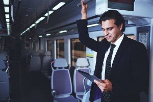 Businessman working with tablet on the way to work